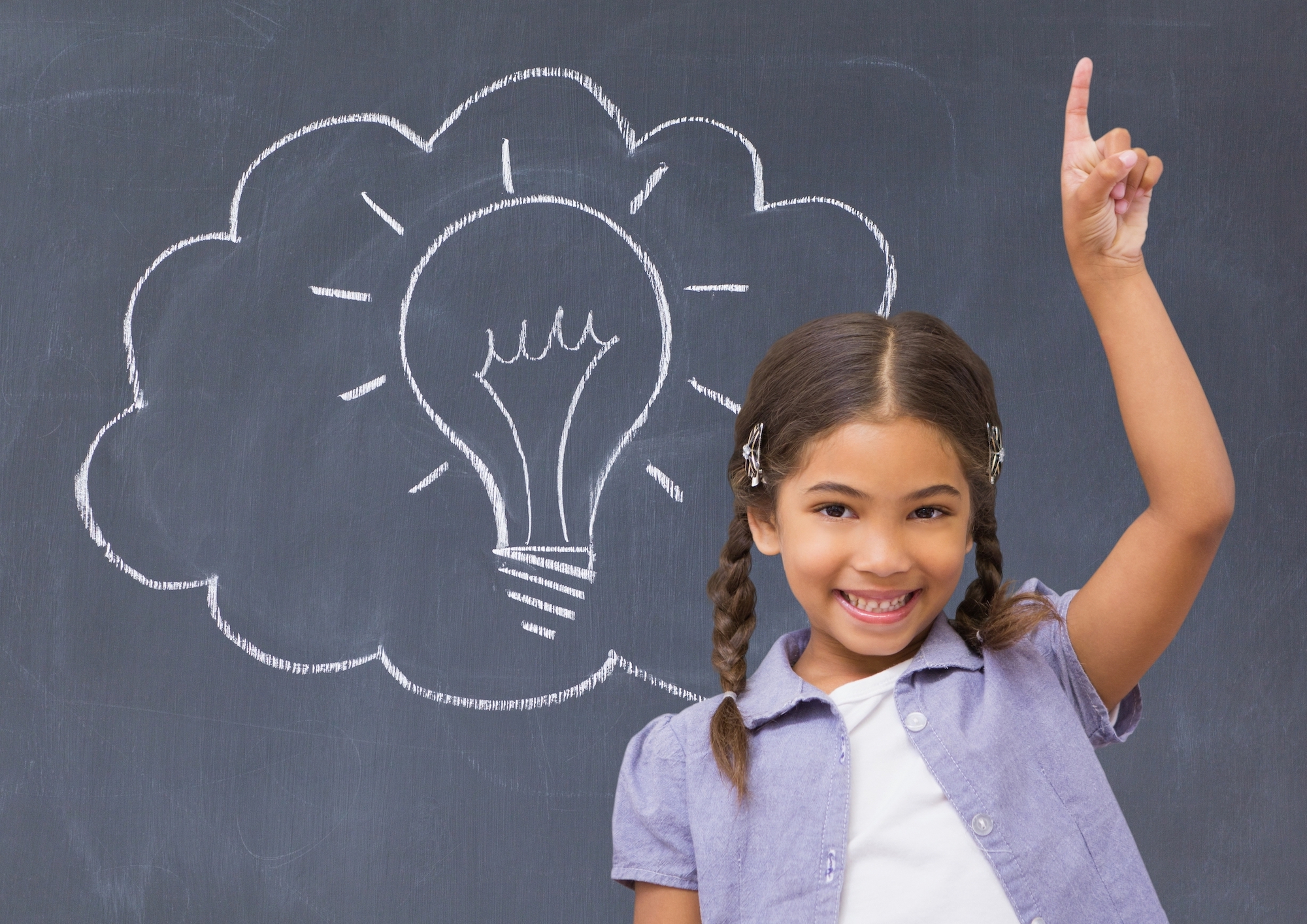 Schoolgirl raising her hand in front of a blackboard Schoolgirl raising her hand in front of a blackboard